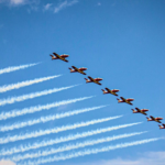 9 Canadian Forces Snowbirds aircrafts flying in the sky